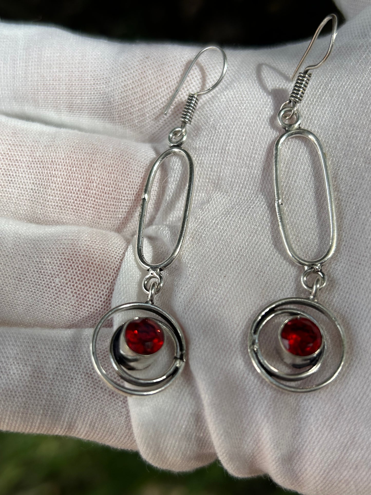 Facet cut Mozambique garnet drop earrings in artistic sterling silver setting