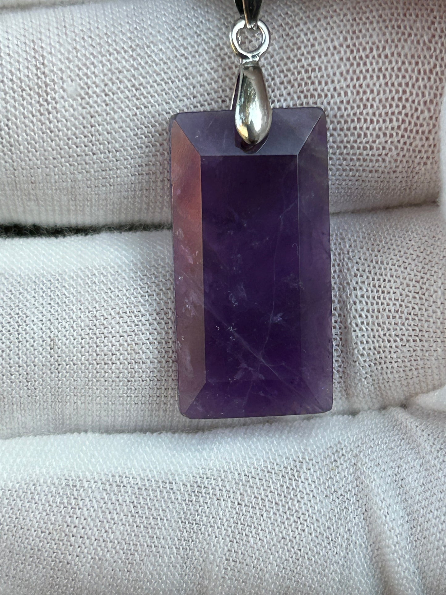 Amethyst rectangular polished pendant with silver pendant attachment and black cord necklace