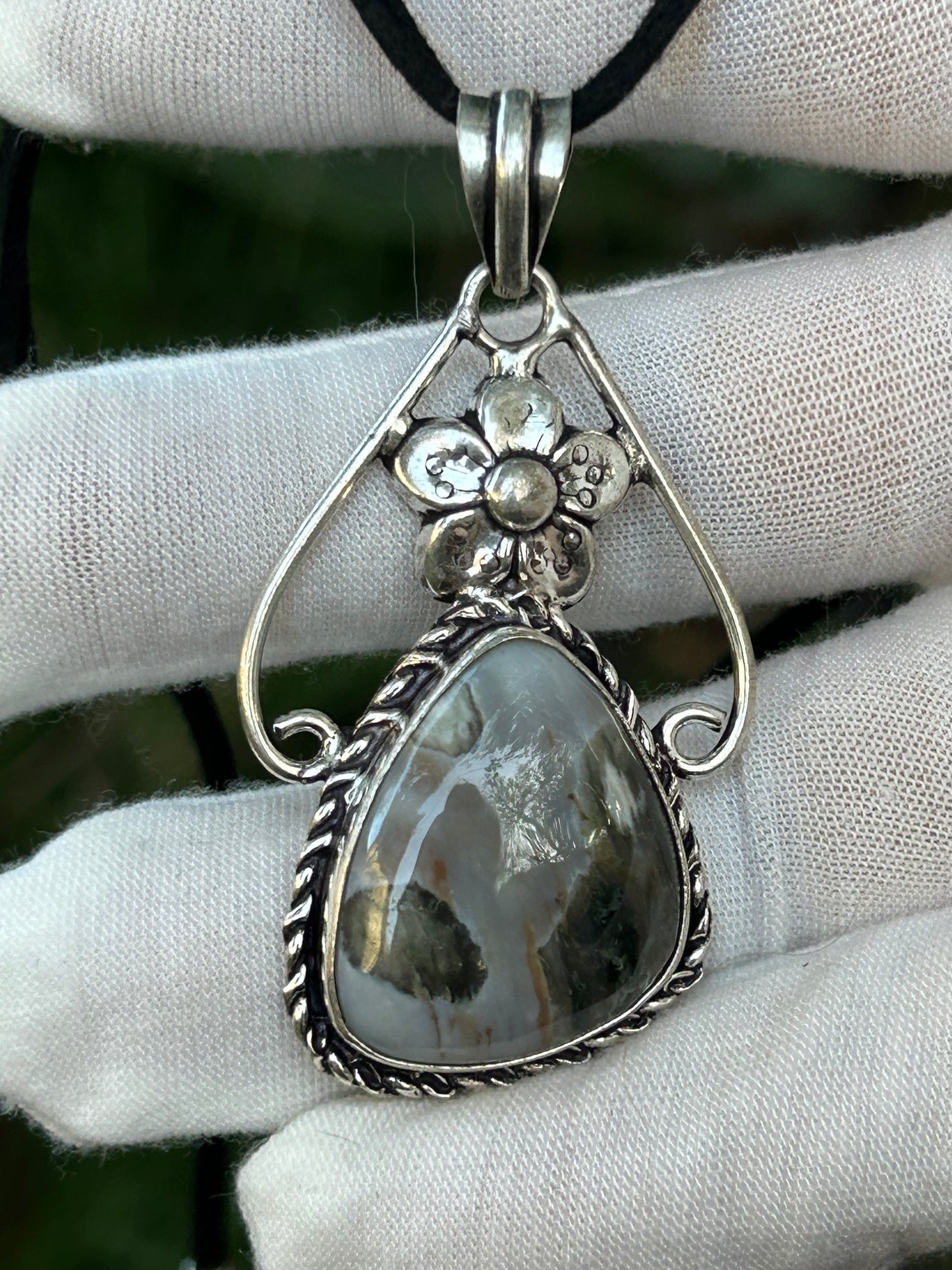 Irregular shape siver moss agate in ornate flower theme in antique 925 sterling silver setting with black cord necklace