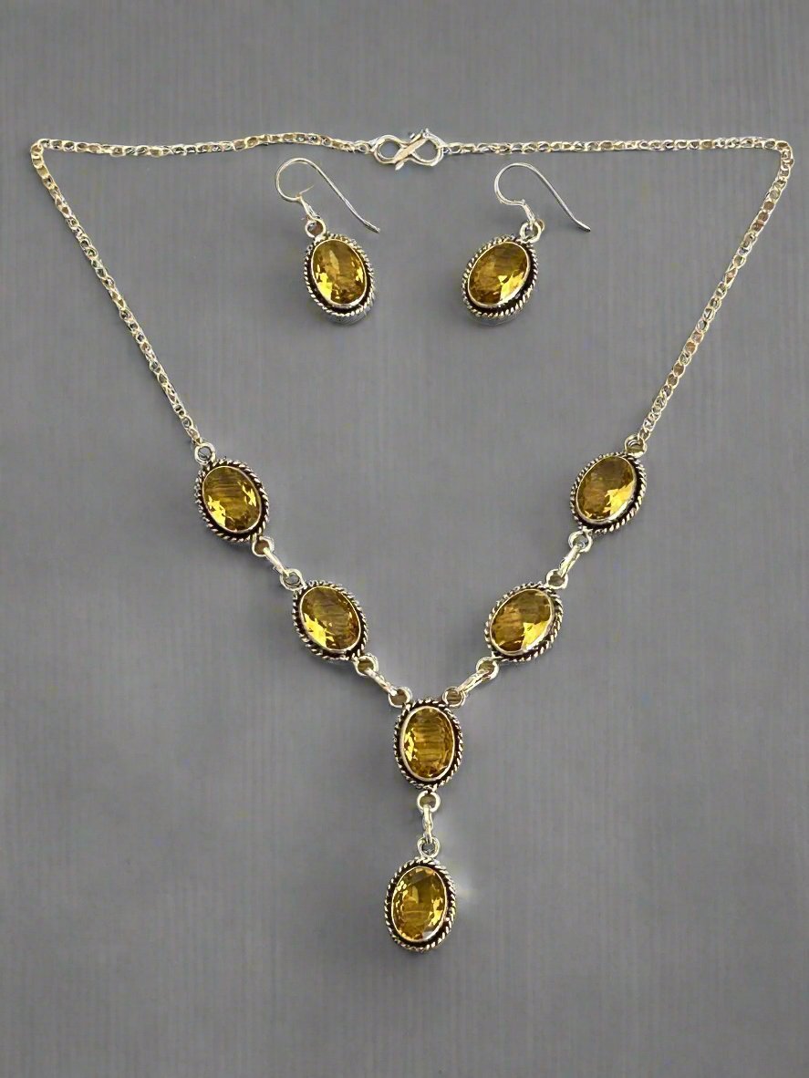 Citrine and 925 silver earrings and necklace set. necklace has six faceted citrine gems and the earrings have one faceted citrine each
