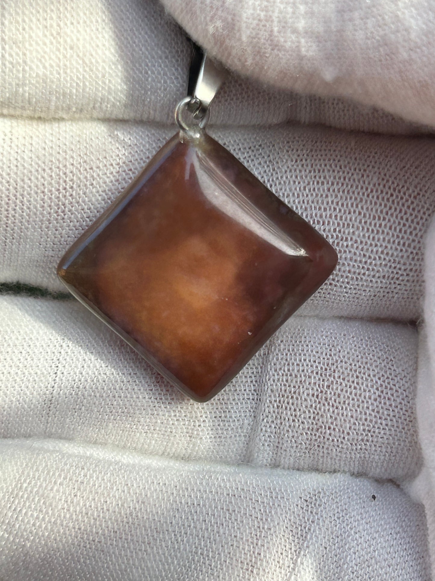 Lilac and brown polished jasper pendant with silver pendant attachment and black cord necklace