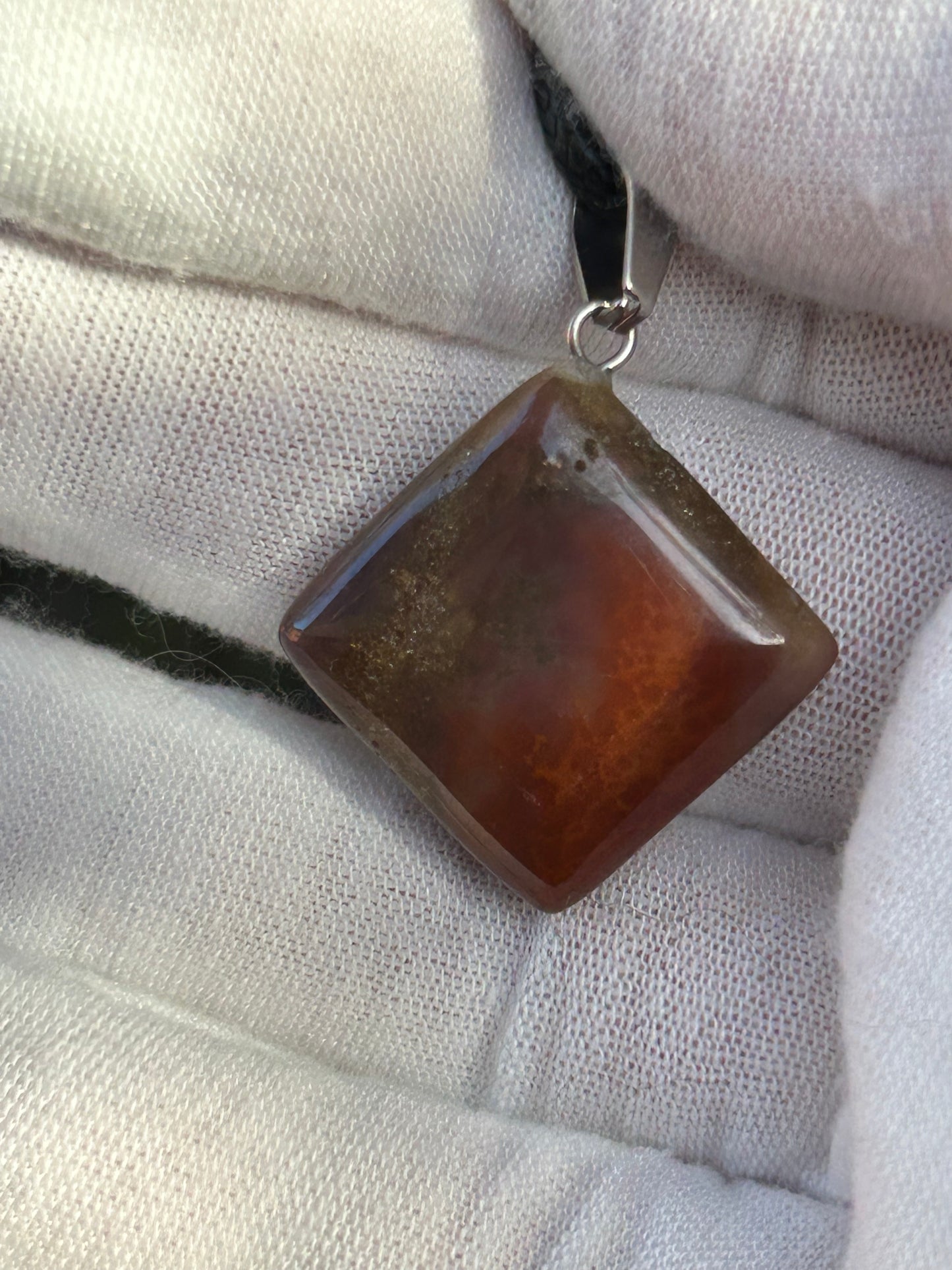 Polished Ocean jasper pendant with silver pendant attachment and black cord necklace