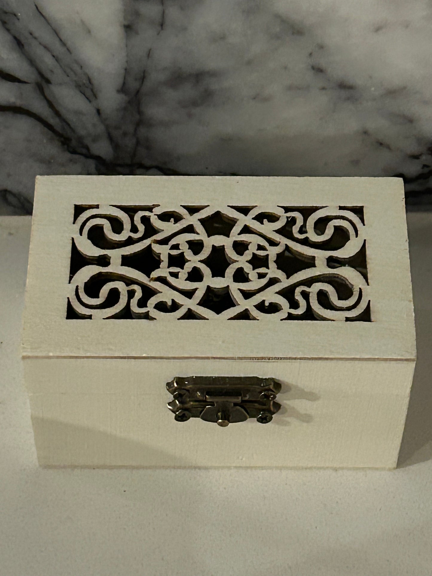 wooden box with intricate cutout design on the top