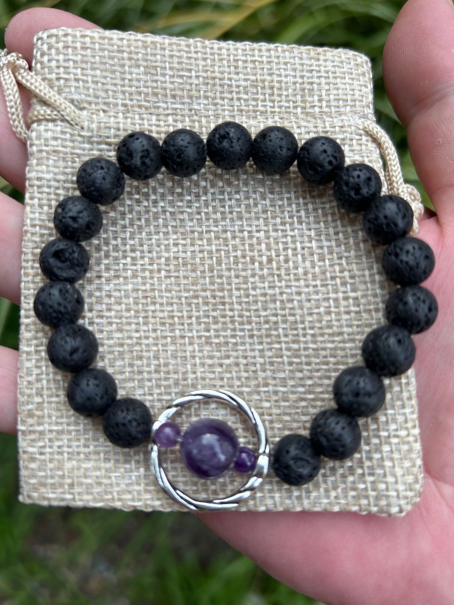 lava rock bead bracelet with 3 amethyst beads encircled with round silver embellishment on hessian bag