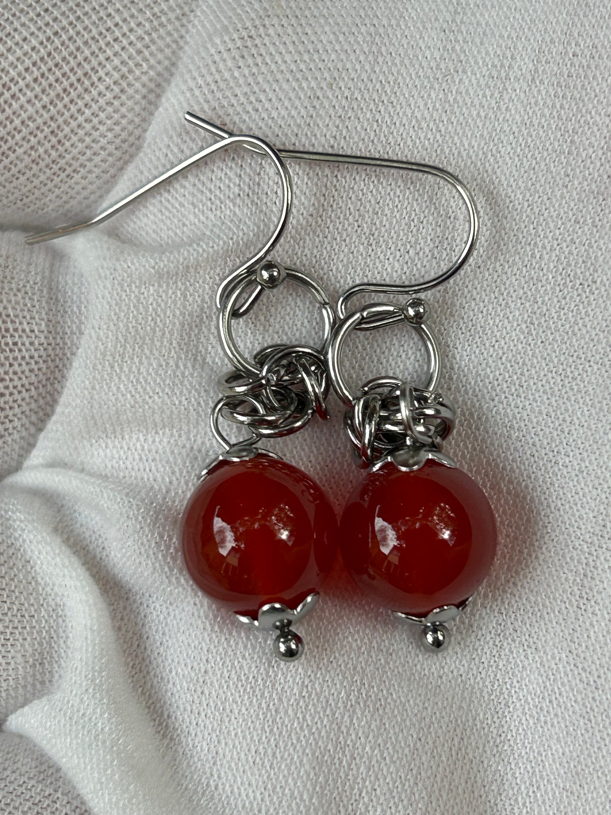 small red carnelian round bead drop earrings with silver detail