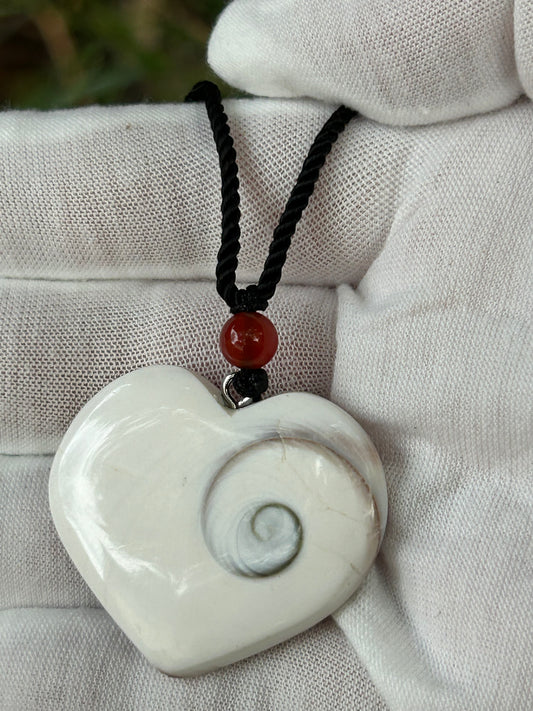 White shell pendant with swirl embedded and black cord necklace