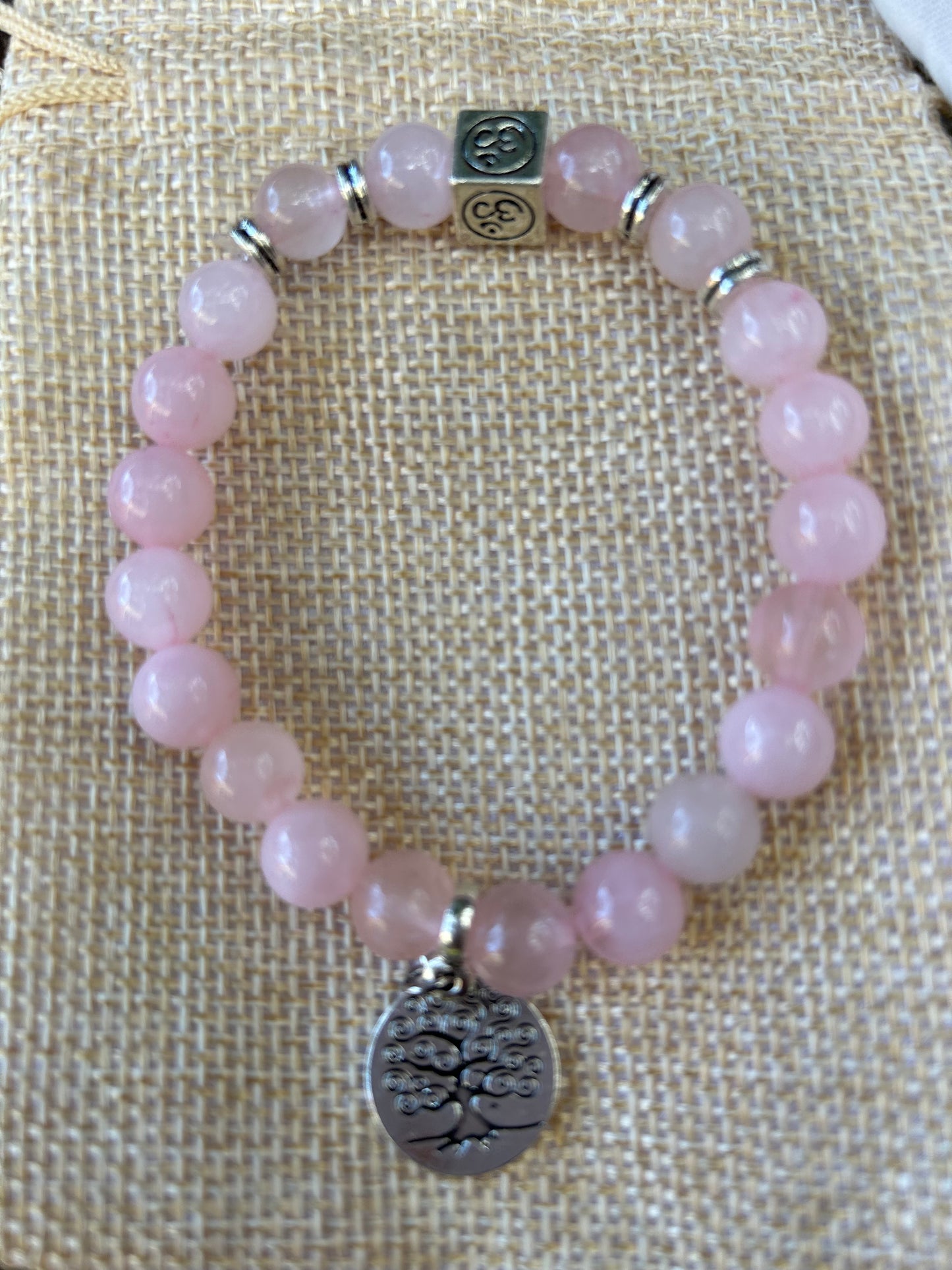 Rose quartz crystal polished bead bracelet with silver detail om symbol and tree of life charm