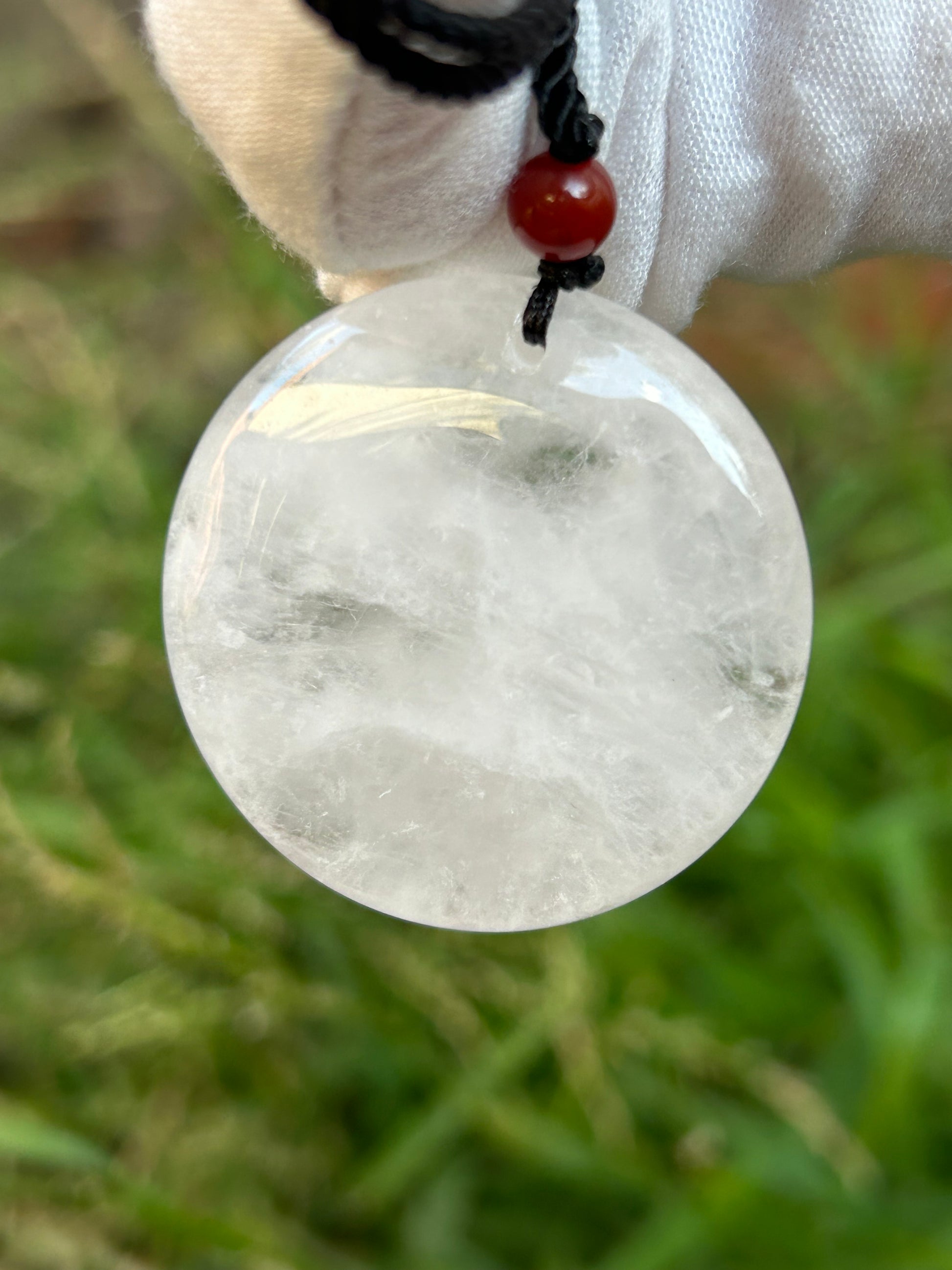 Large Clear Quartz Circular Pendant with red bead and black cord necklace