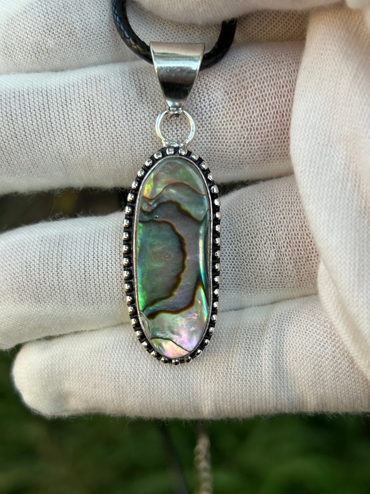 Brightly coloured Paua Abalone Shell Pendant in unique sterling silver setting