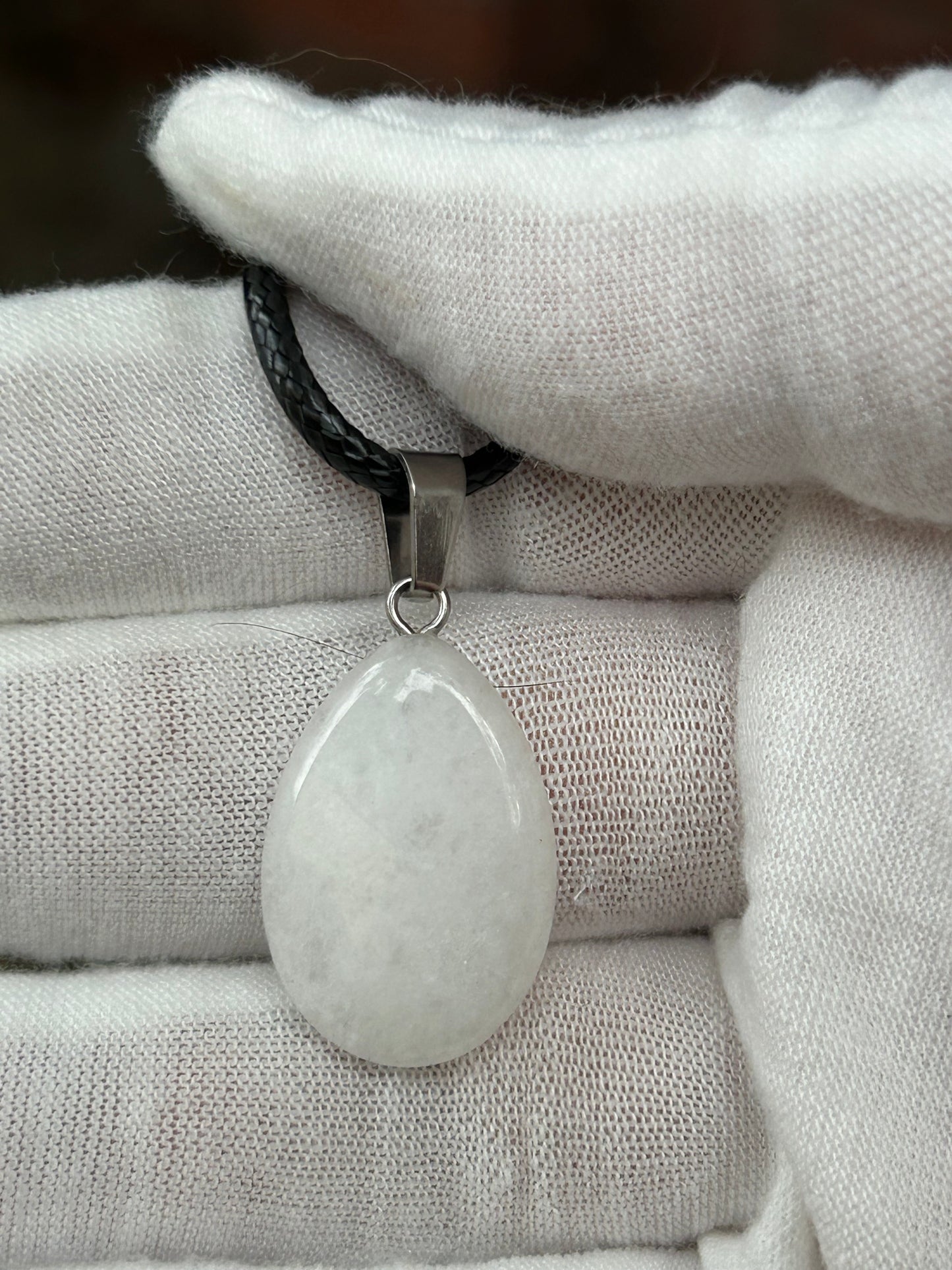 White Quartz Polished Rain Drop Pendant with silver pendant attachment and black cord necklace
