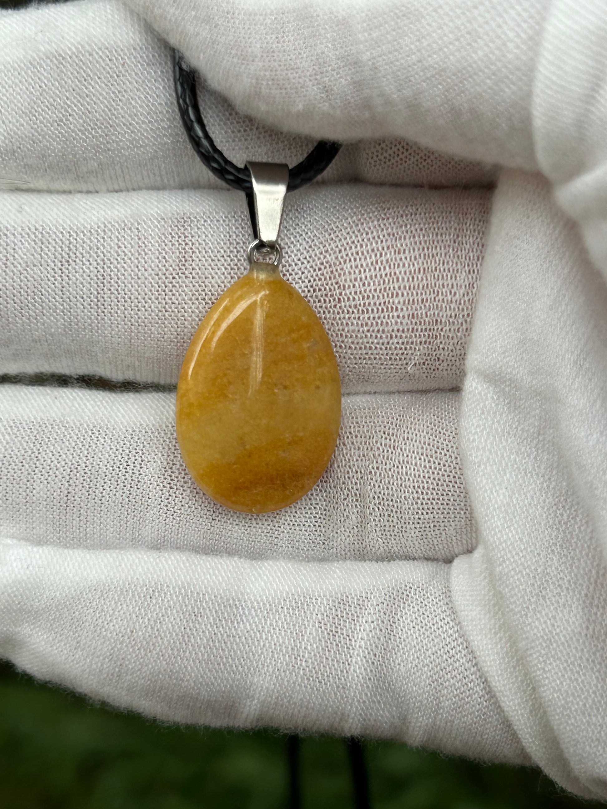 Yellow Jade Polished Rain Drop Pendant with silver pendant attachment and black cord necklace