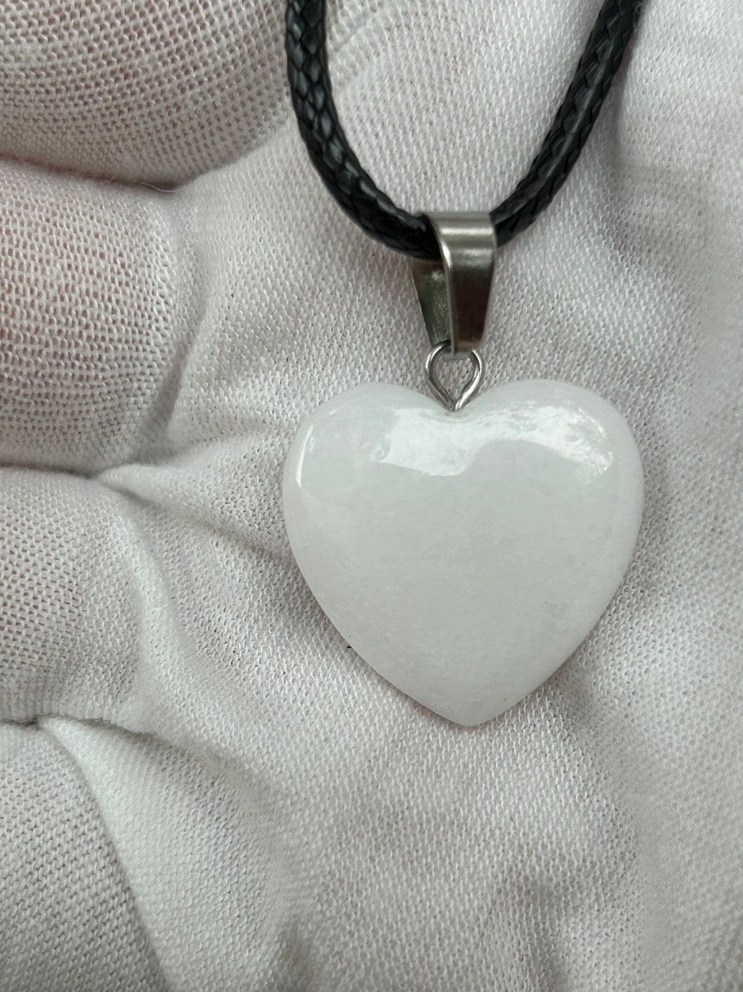 White Jade Heart Polished Pendant with silver pendant fixture and black cord necklace