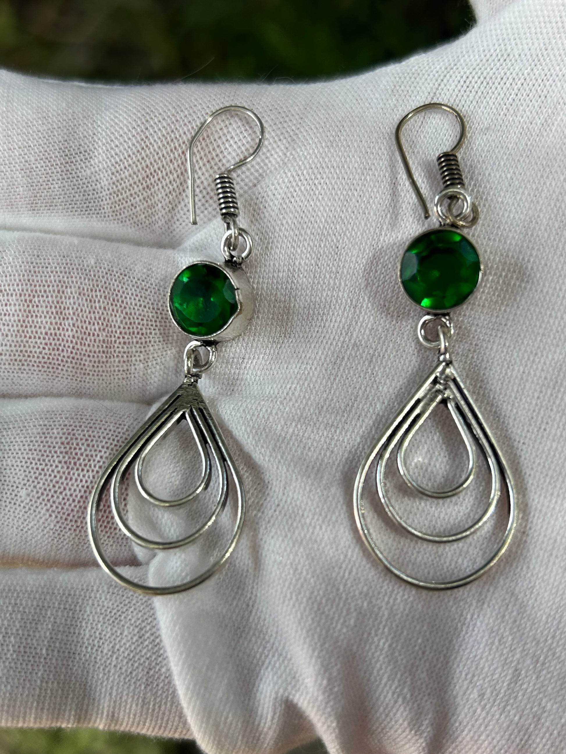 Faceted green emerald drop earrings with 3 tiered raindrop tear drop hanging sterling silver details