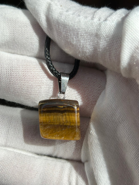 Small tigers eye polished square pendant with silver pendant attachment and black cord necklace