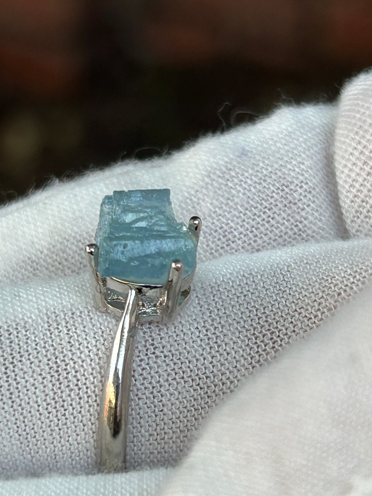 Raw aquamarine crystal set in simple silver adjustable ring side view