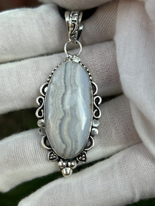 Medium blue lace agate polished oval pendant set in handmade ornate sterling silver setting