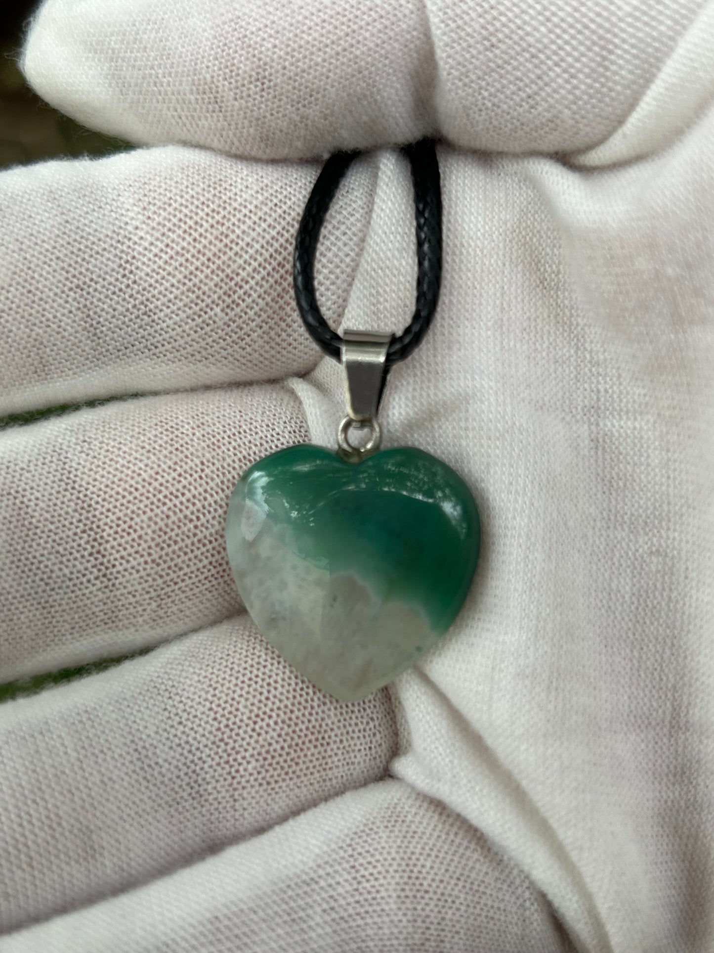 Green and white agate polished heart pendant with silver pendant attachment and black cord necklace