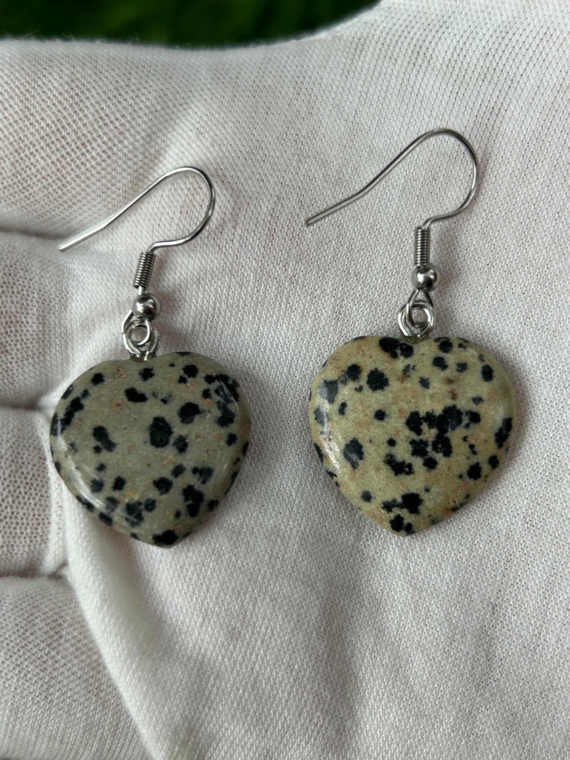 Polished Dalmatian Jasper heart shaped earrings with silver attachments