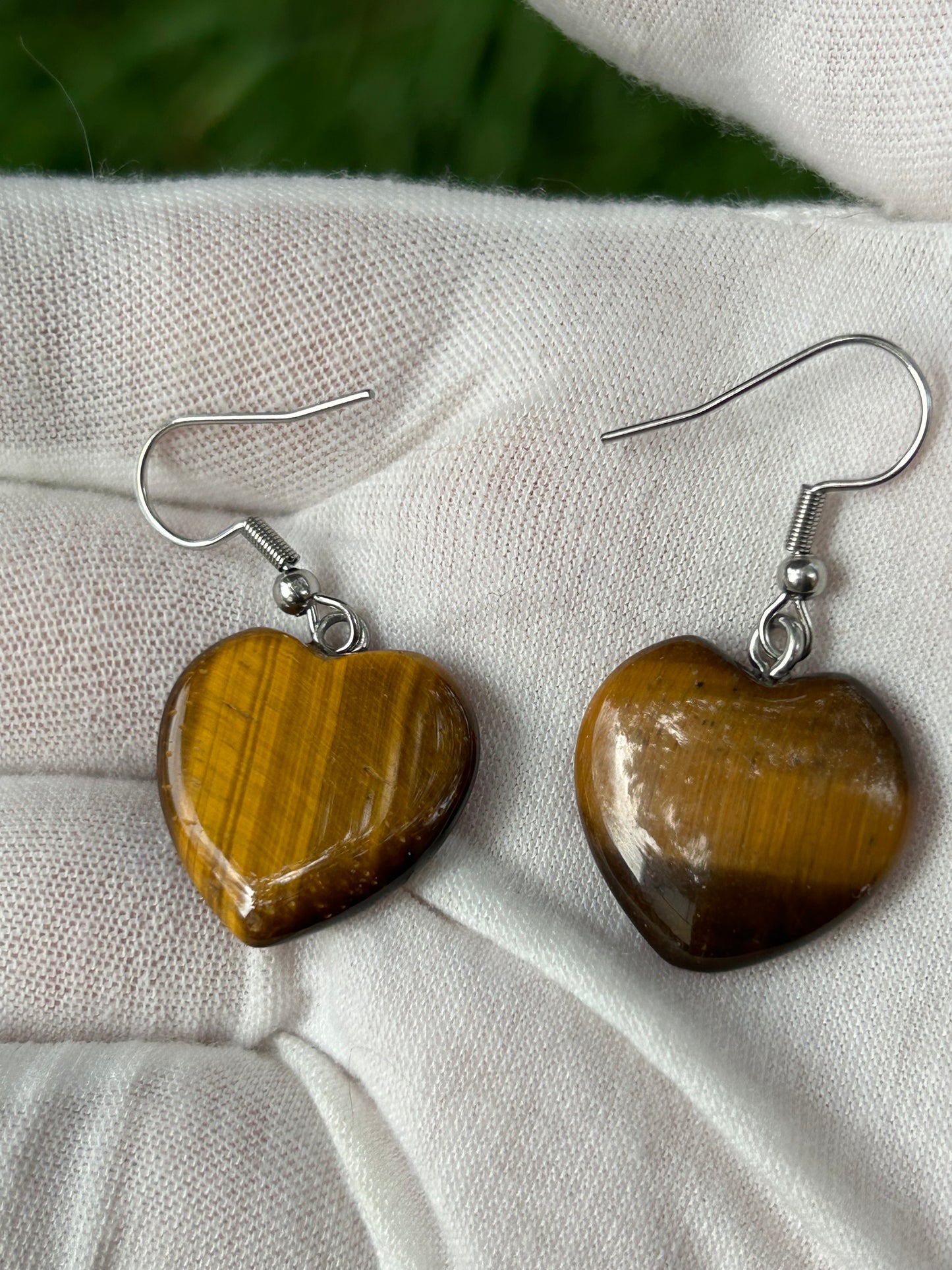 polished tigers eye heart shaped earrings with silver hooks