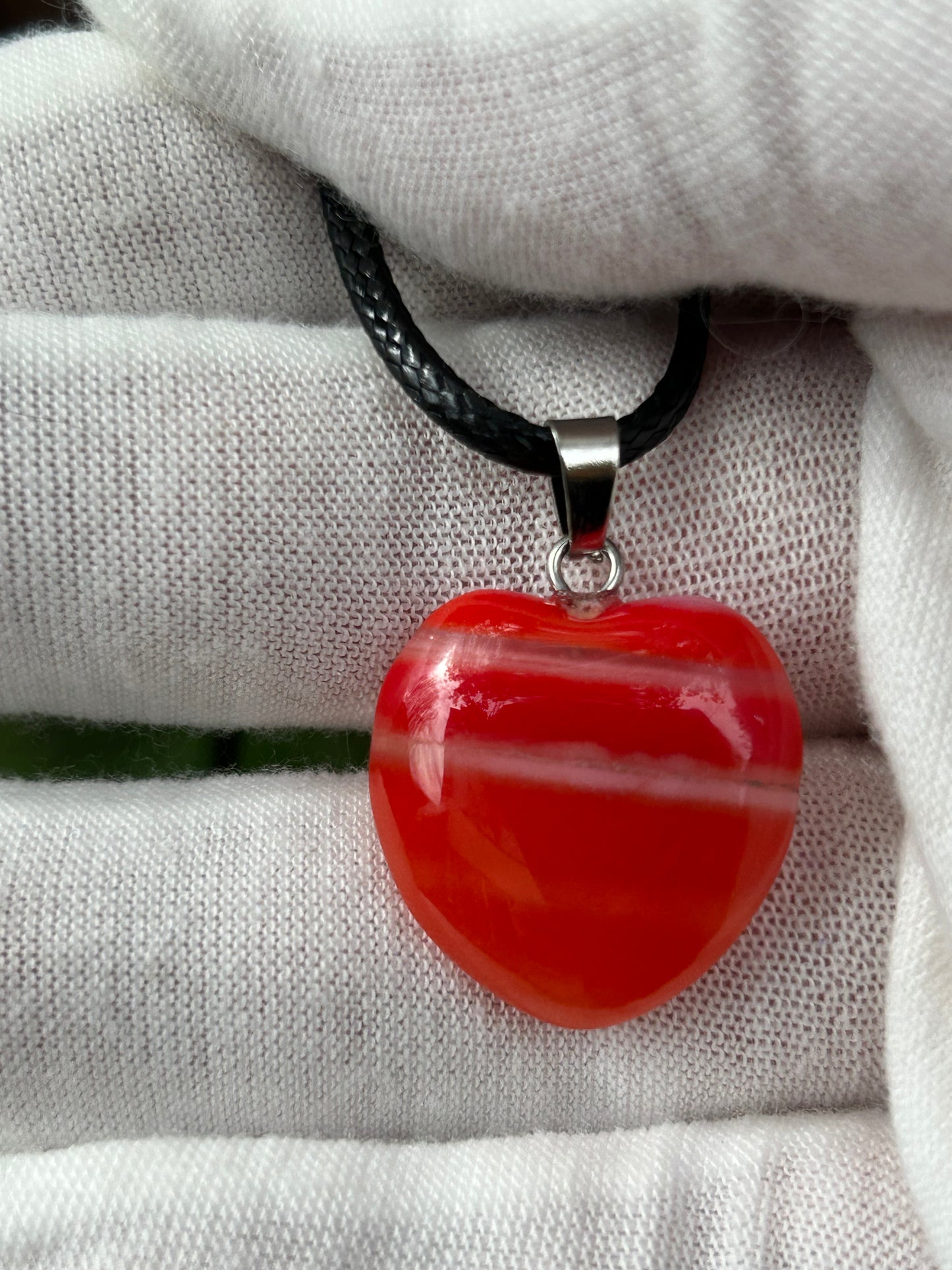 Red Agate Polished heart pendant with silver pendant attachment and black cord necklace