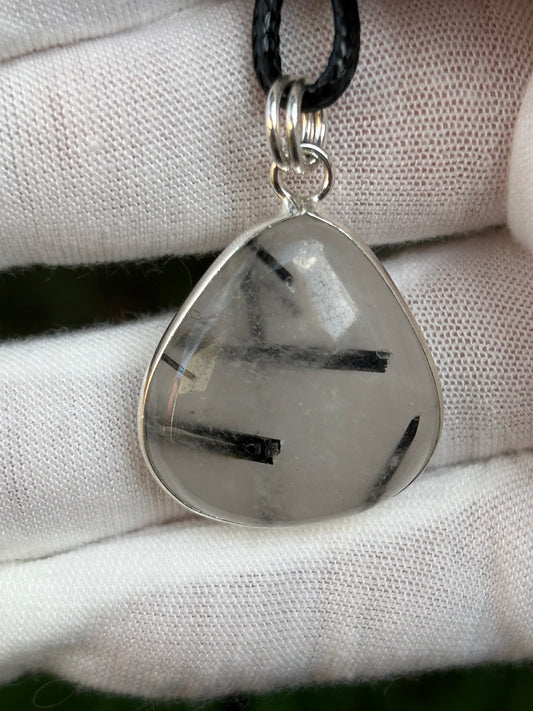 black tourmaline in clear quartz water drop shaped shaped pendant set in 925 sterling silver with black cord necklace