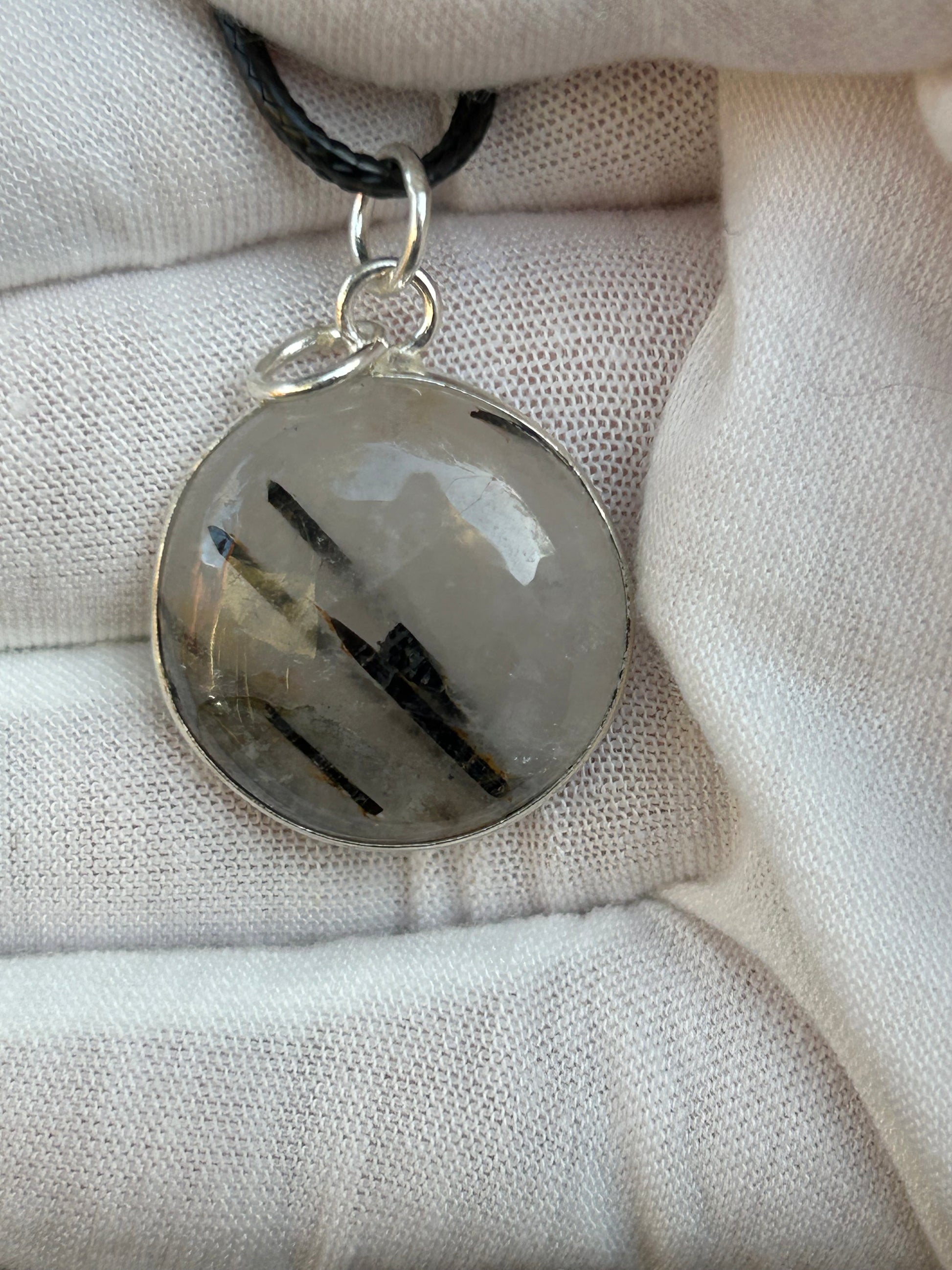 black tourmaline in clear quartz round shaped pendant set in 925 sterling silver with black cord necklace