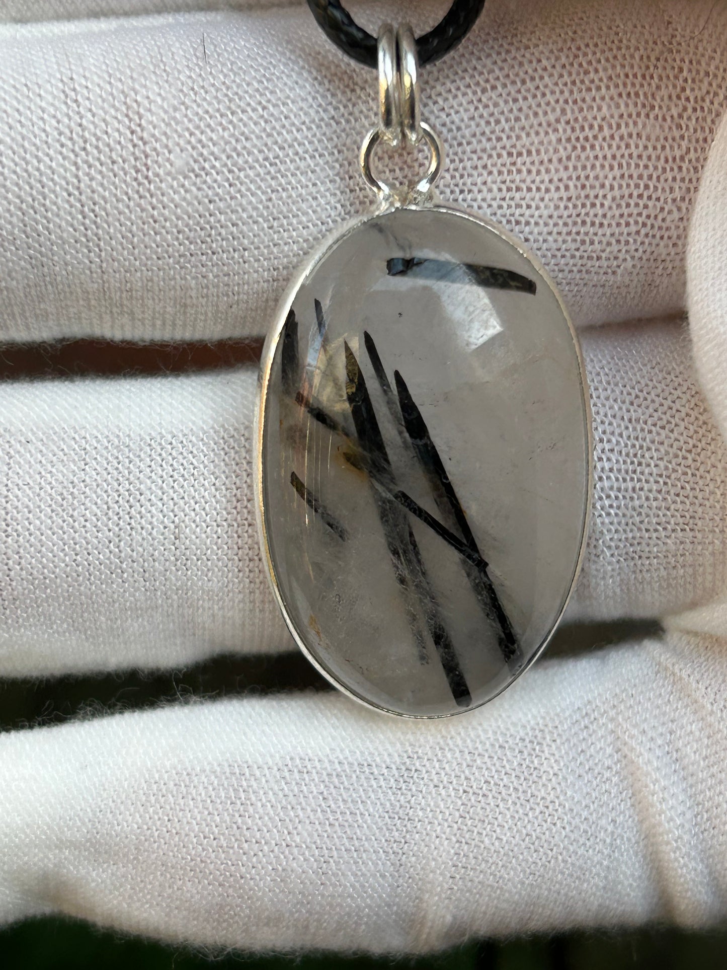 black tourmaline in clear quartz oval shaped pendant set in 925 sterling silver with black cord necklace