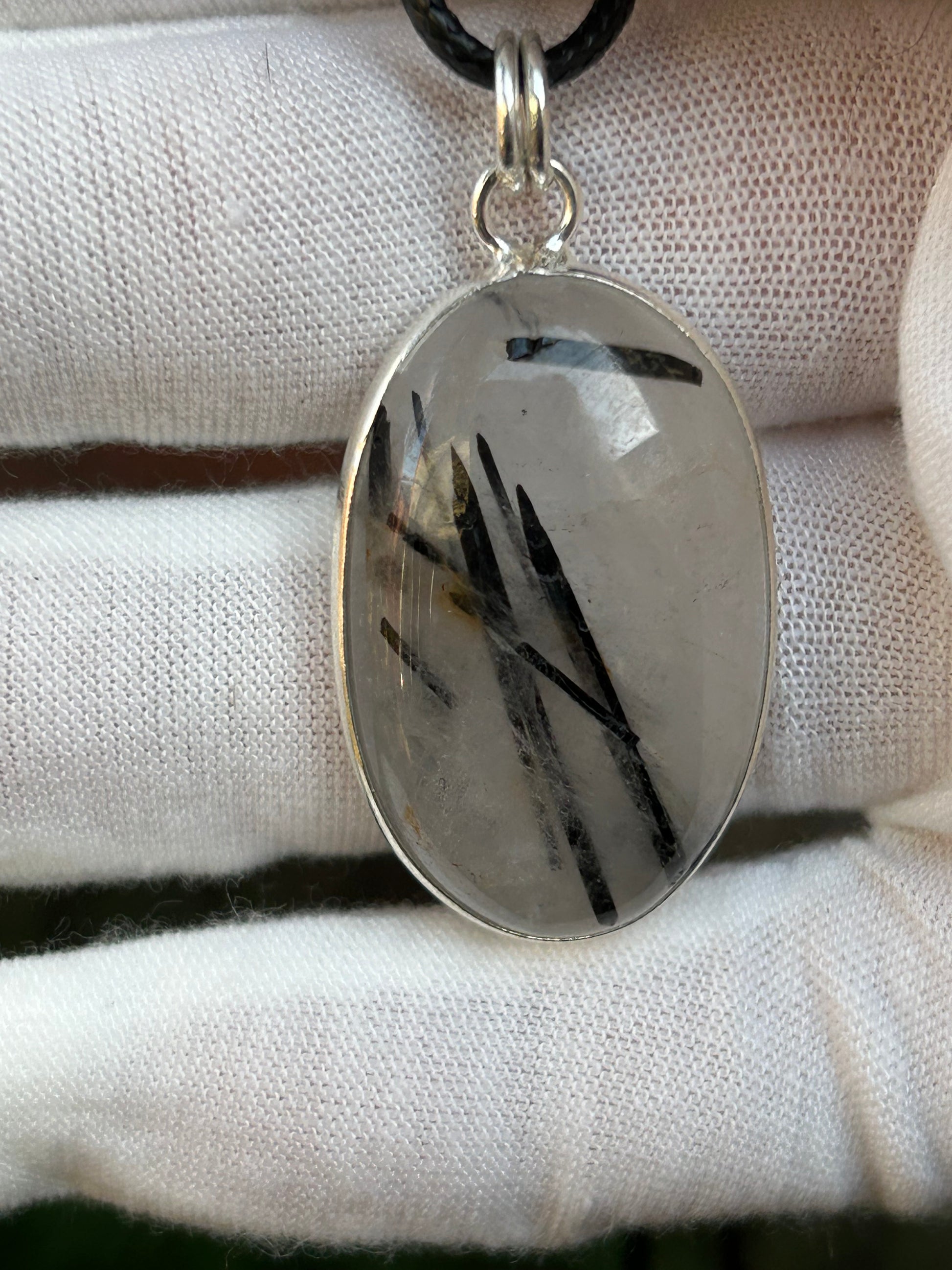 black tourmaline in clear quartz oval shaped pendant set in 925 sterling silver with black cord necklace