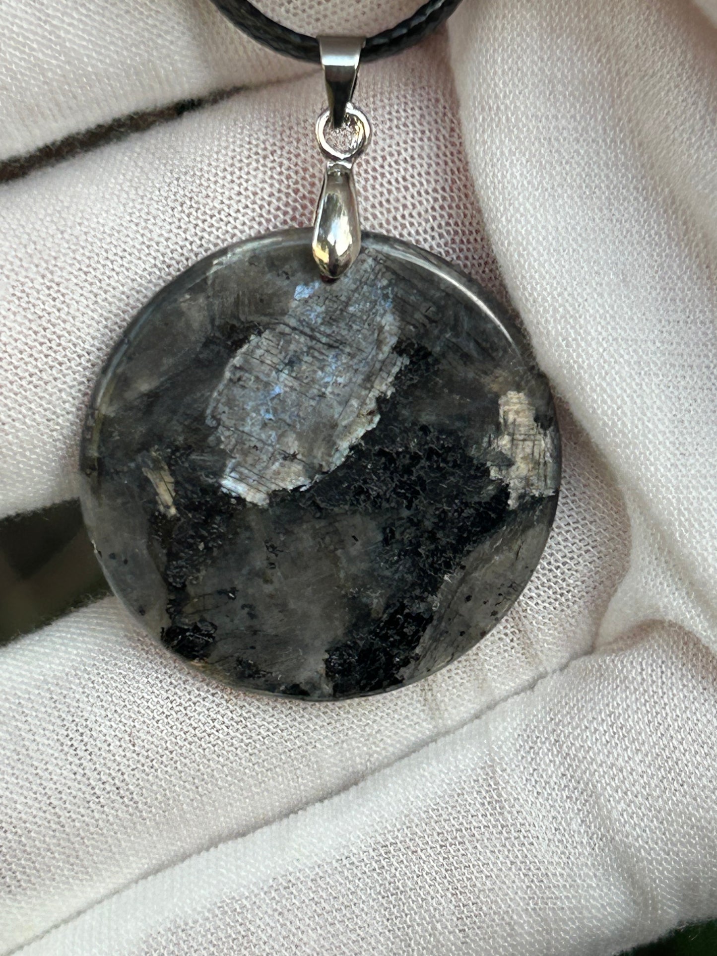 Round Polished Spectrolite pendant silver black gray tones with silver pendant attachment and black cord necklace