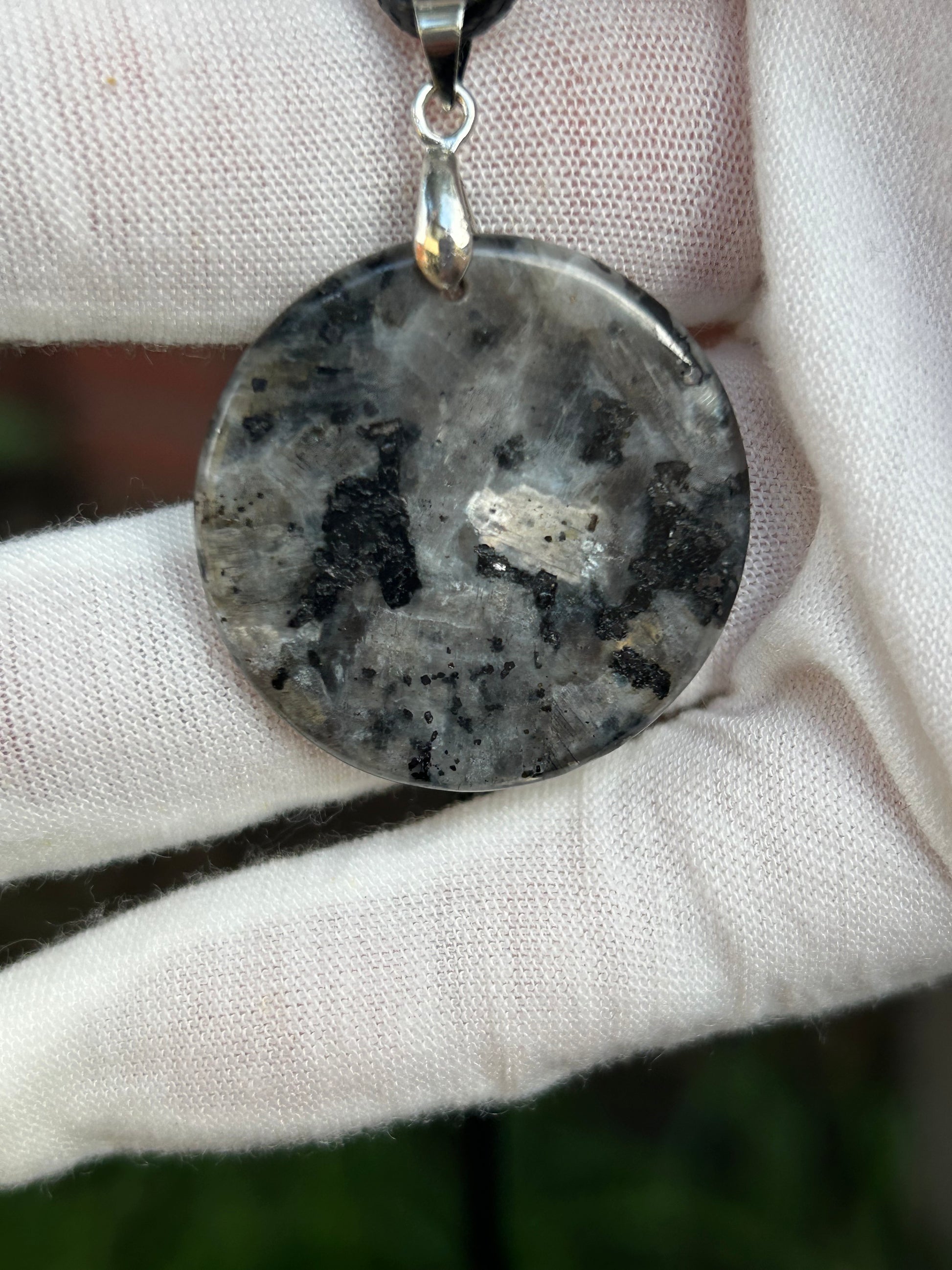 Round Polished Spectrolite pendant silver black gray tones with silver pendant attachment and black cord necklace