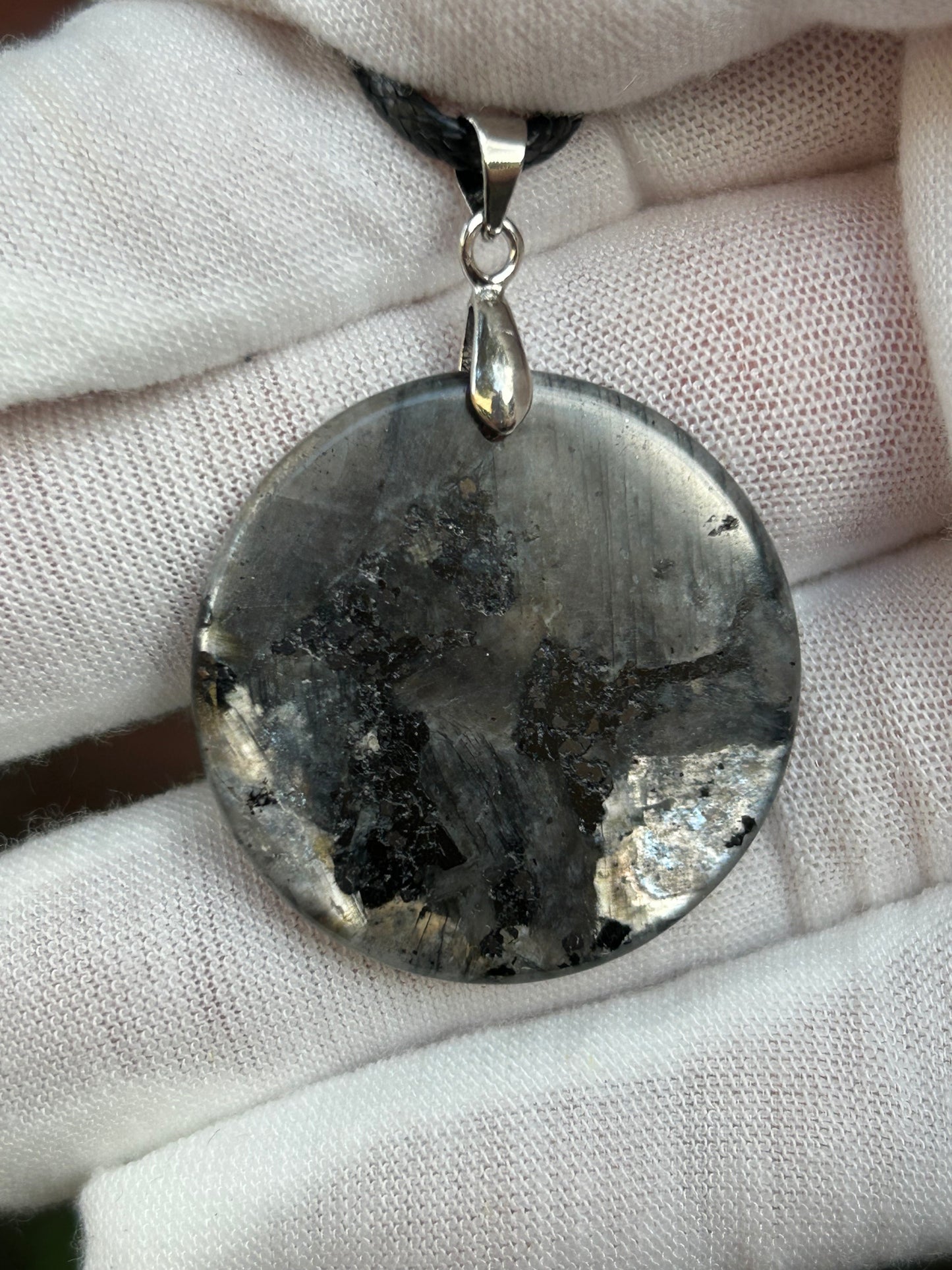 Round Polished Spectrolite pendant silver black gray tones with silver pendant attachment and black cord necklace