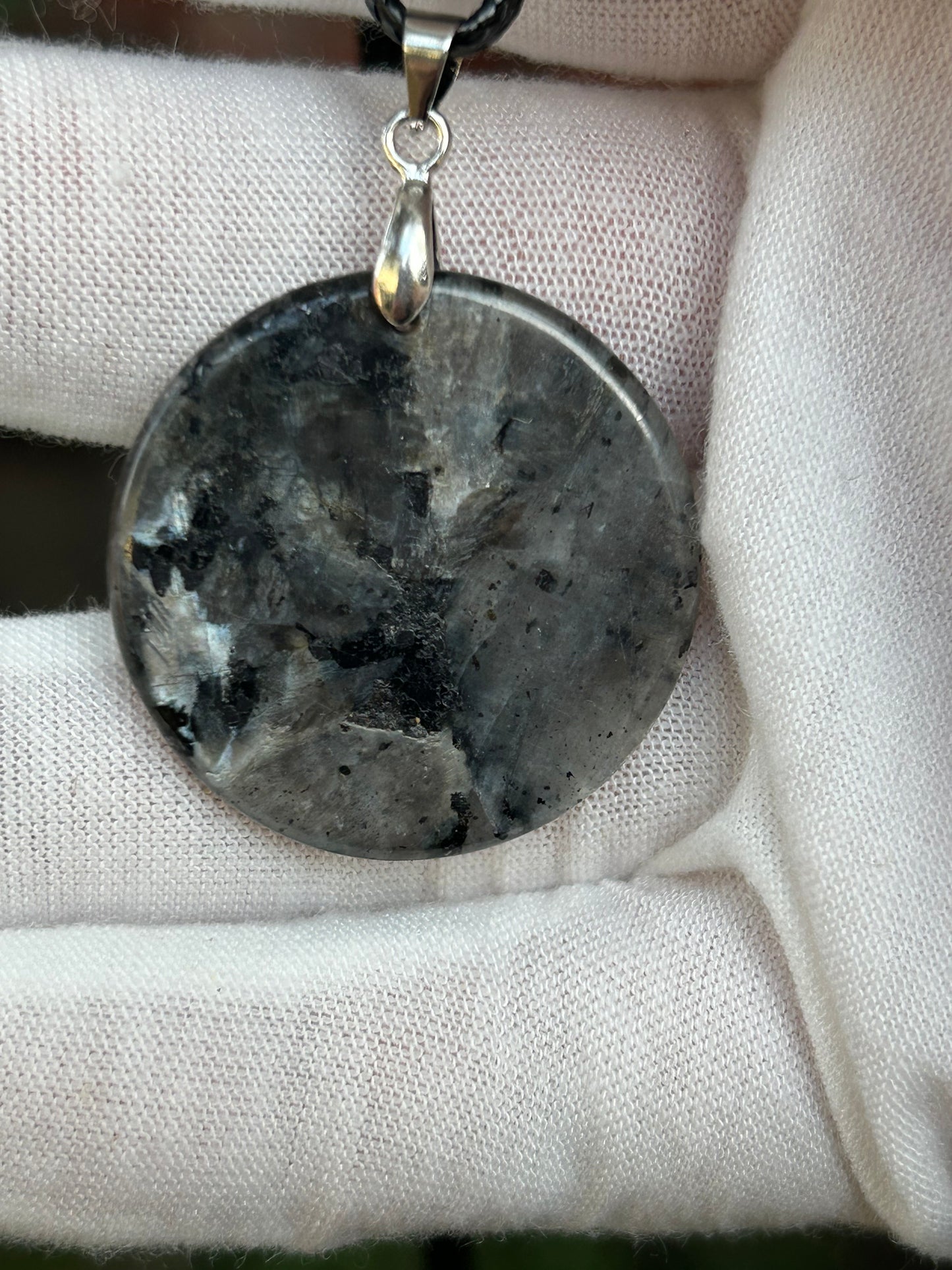 Round Polished Spectrolite pendant silver black gray tones with silver pendant attachment and black cord necklace