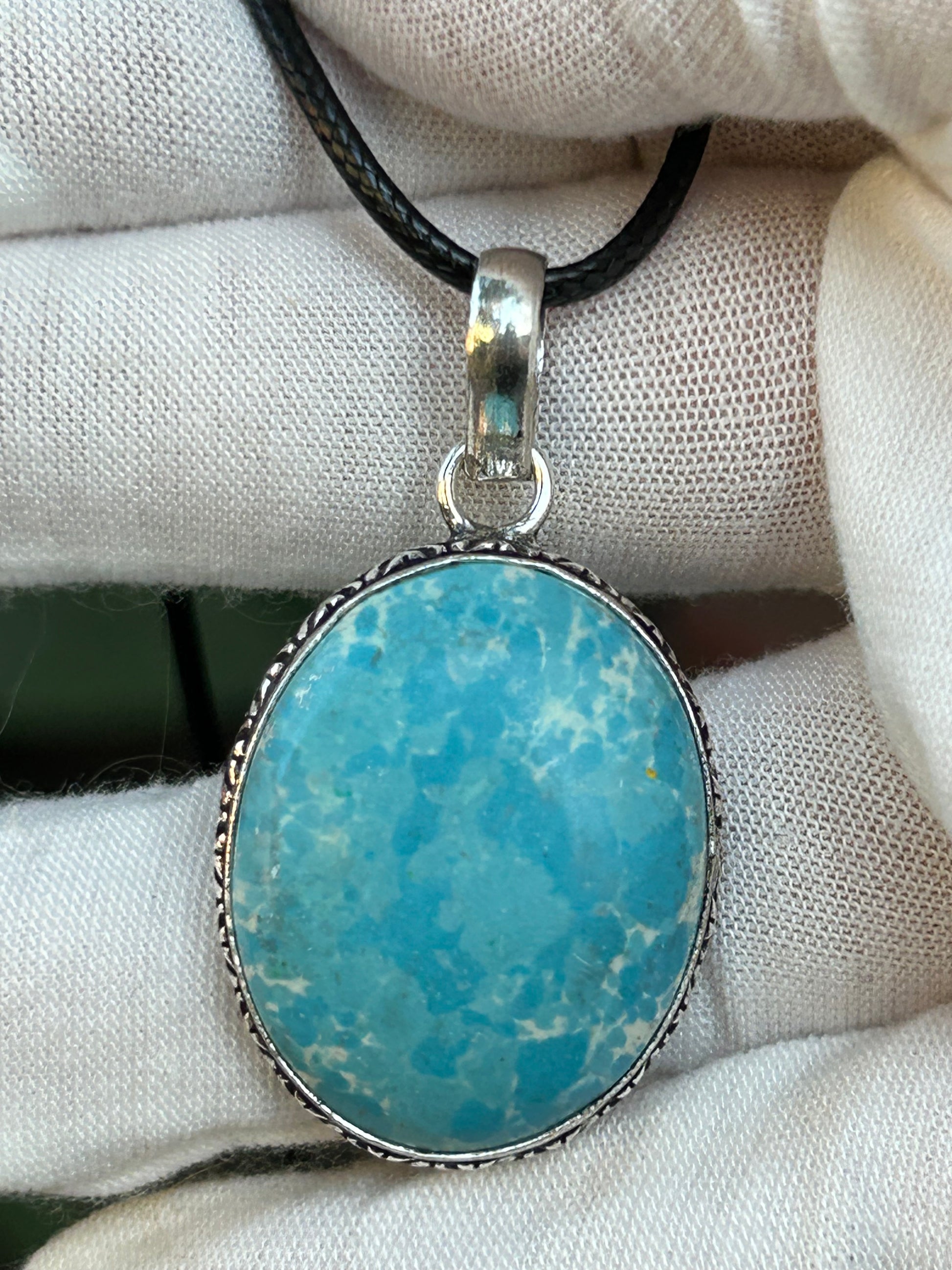 Blue Larimar oval pendant set in 925 Sterling silver setting with black cord necklace