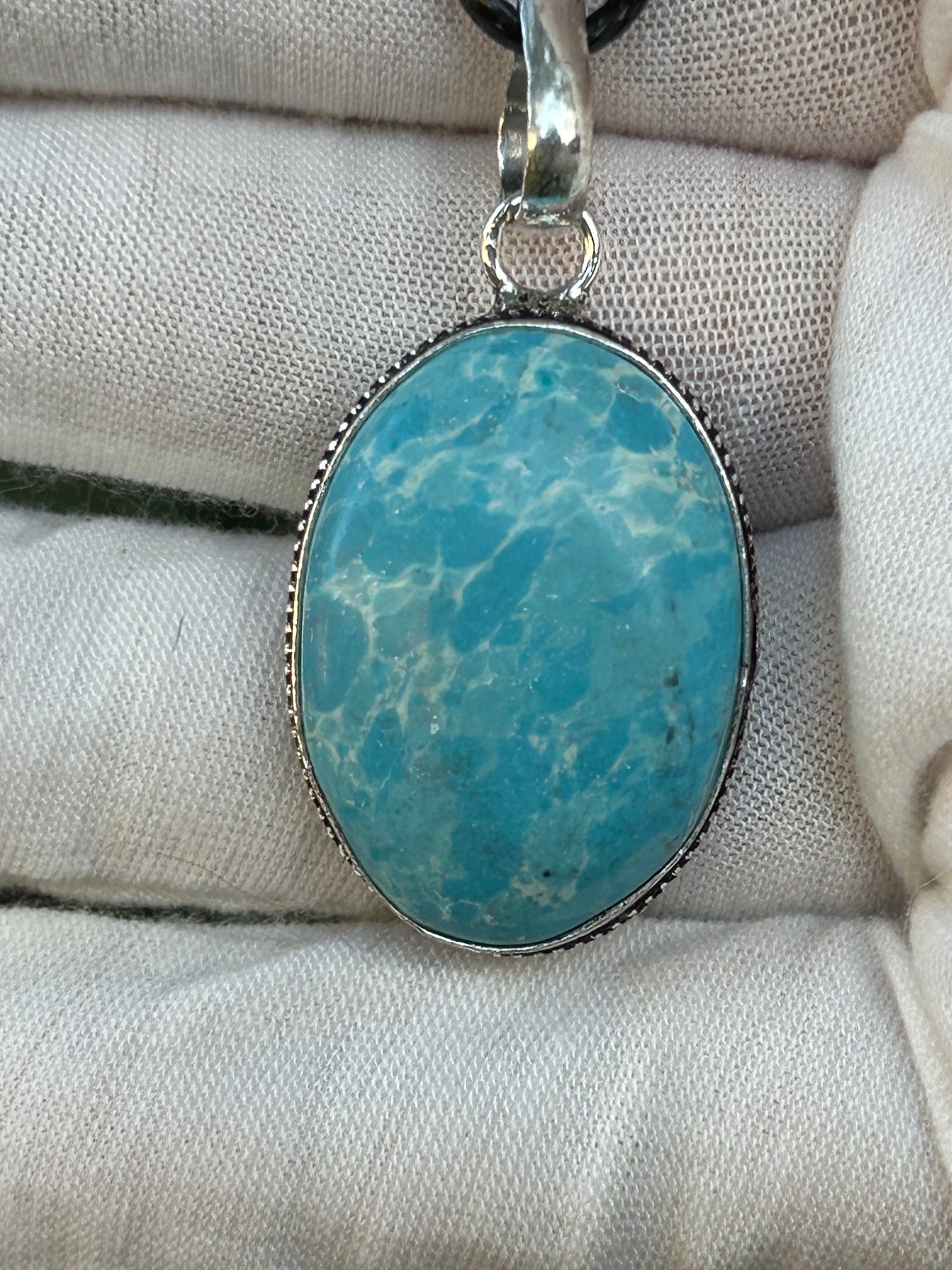 Blue Larimar oval pendant set in 925 Sterling silver setting with black cord necklace