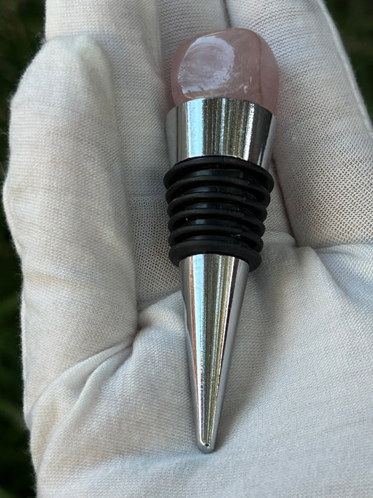 Silver wine bottle stopper with a cube of rose quartz on the top