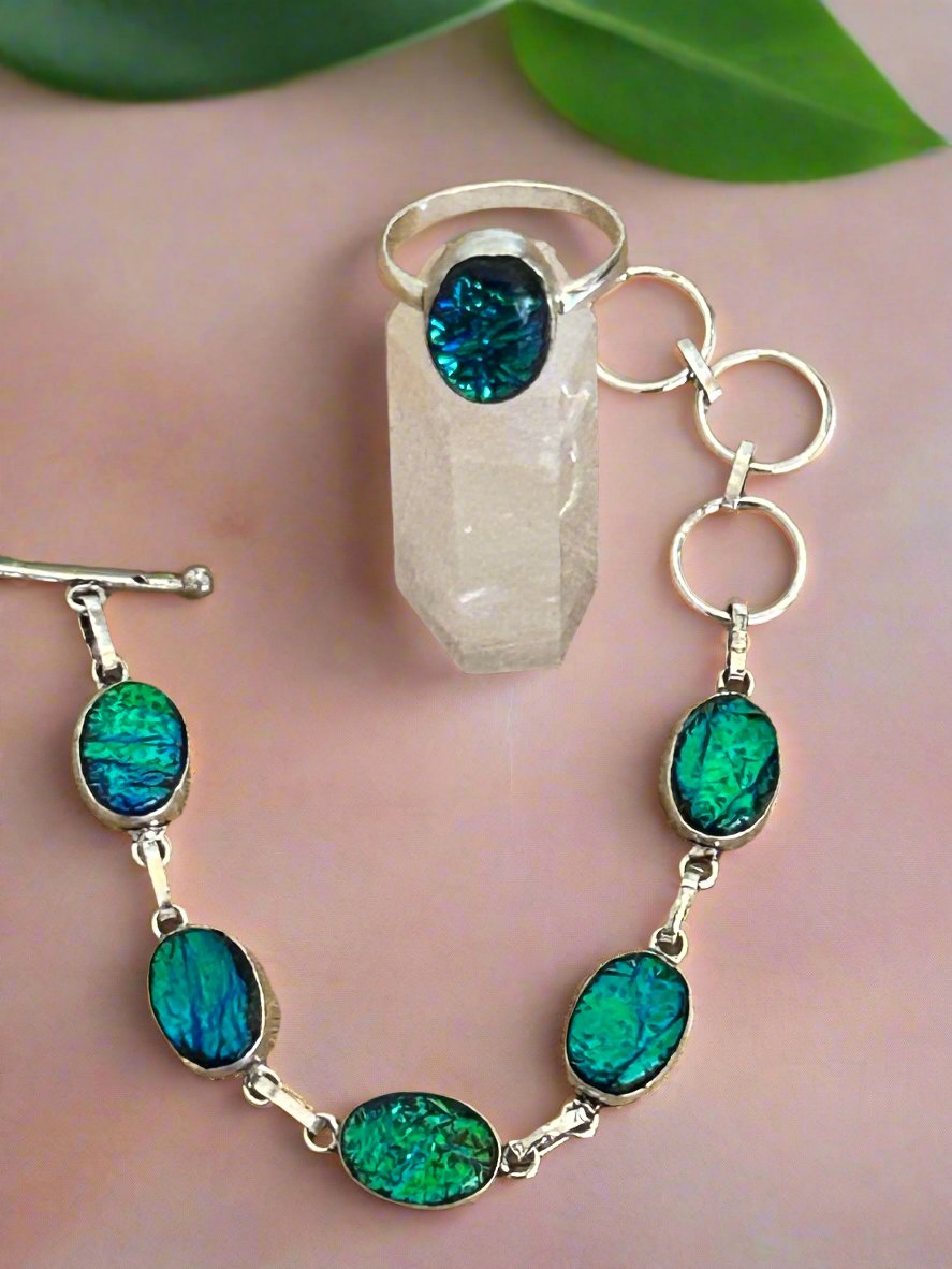 Ammolite green blue tones and 925 Sterling silver jewellery set. the bracelet has 5 ammolite gems and the ring has one large ammolite