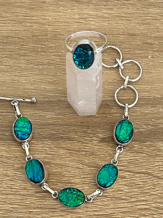 Ammolite green blue tones and 925 Sterling silver jewellery set. the bracelet has 5 ammolite gems and the ring has one large ammolite
