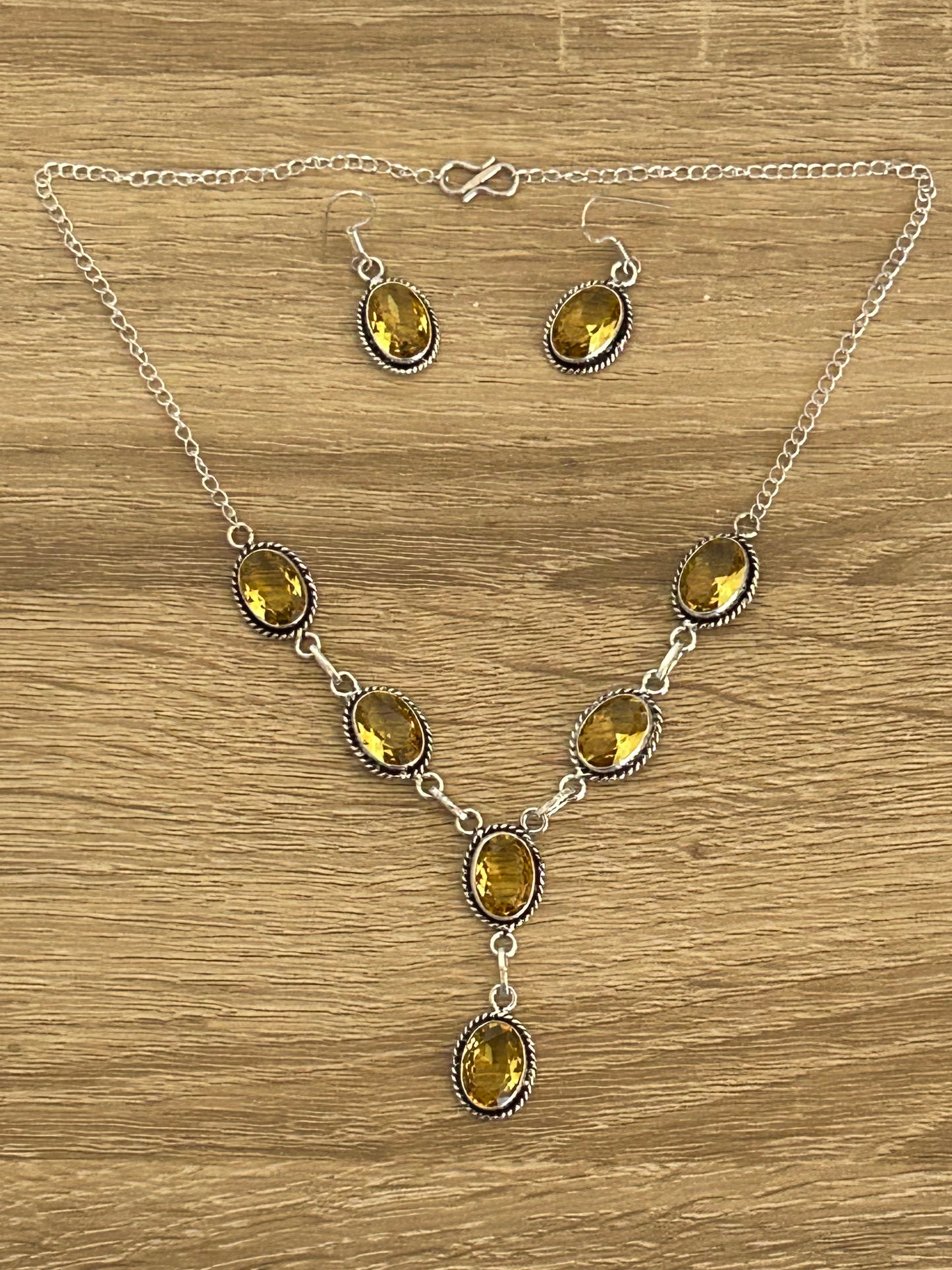 Citrine and 925 silver earrings and necklace set.  necklace has six faceted citrine gems and the earrings have one  faceted citrine each