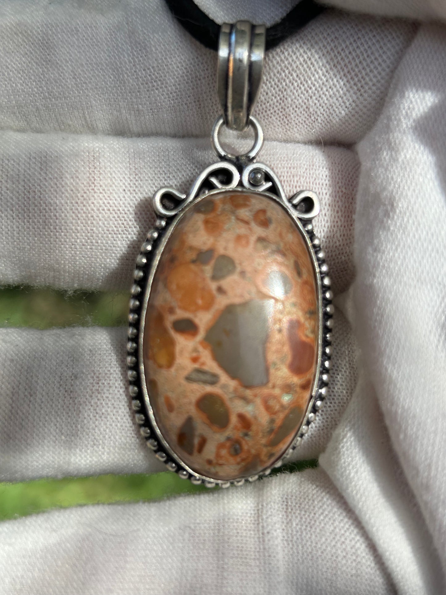 Oval brown and orange tones birds eye jasper in antique 925 ornate sterling silver setting with black cord necklace