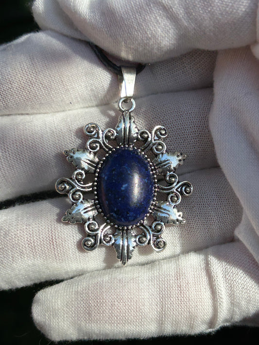 oval lapis lazuli pendent set in ornate antique silver design  with black cord necklace