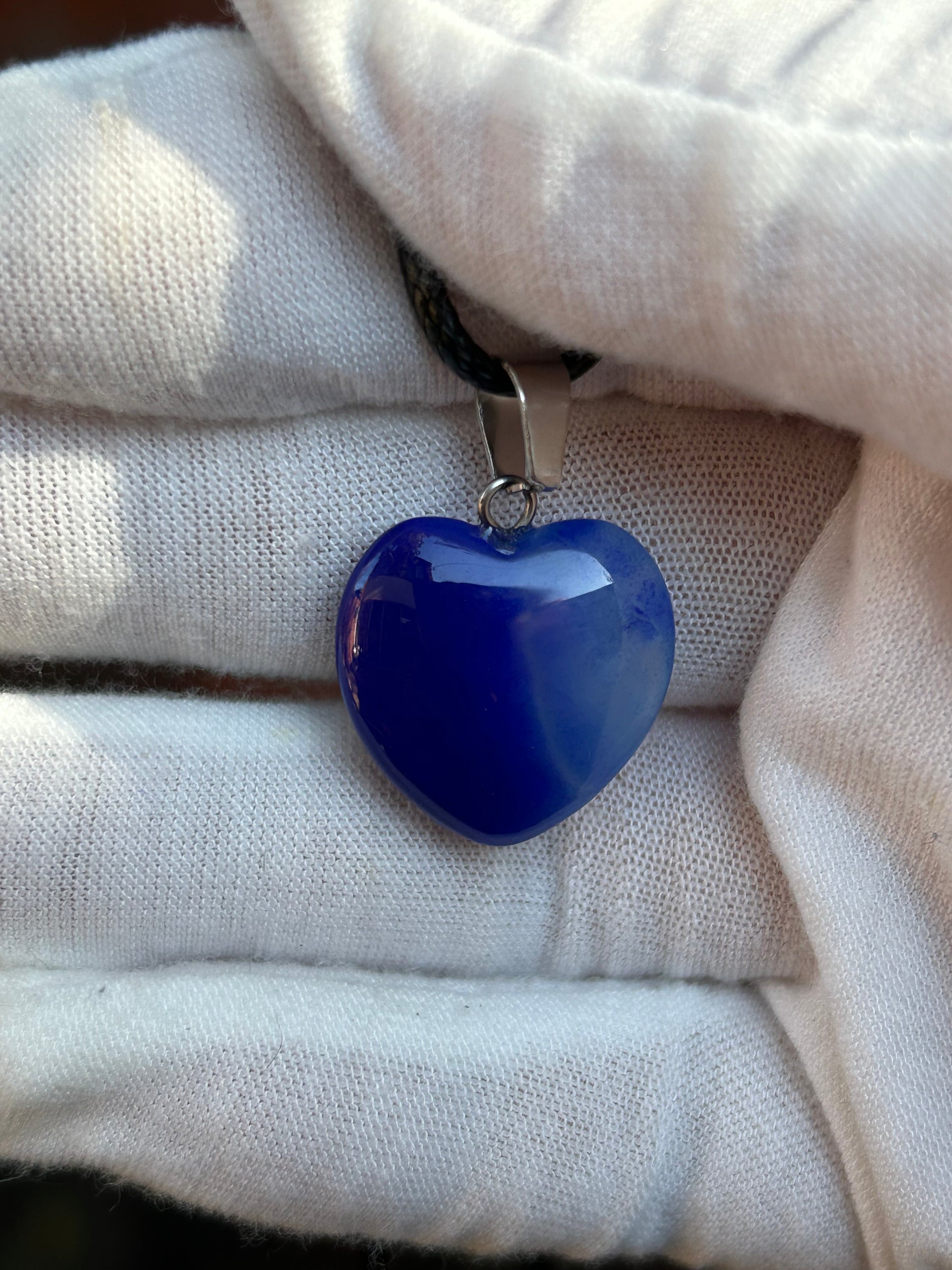 Blue agate polished heart pendant with silver pendant attachment and black cord necklace