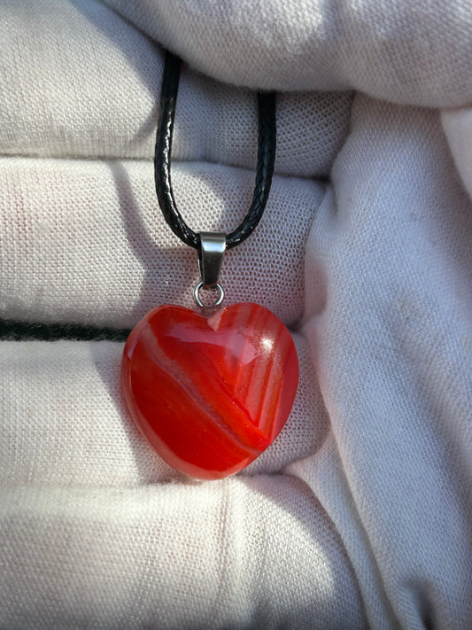 Red agate polished heart pendant with silver pendant attachment and black cord necklace