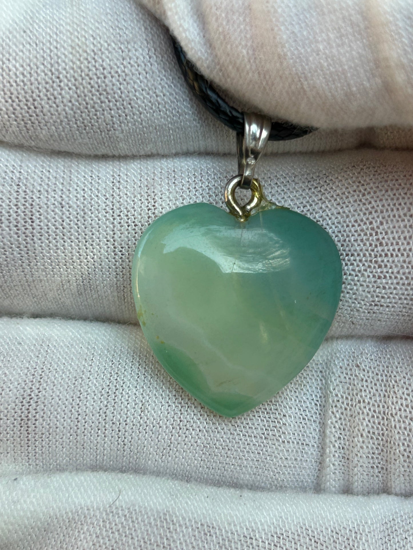 Green agate polished heart pendant with silver pendant attachment and black cord necklace