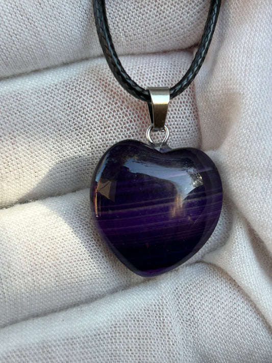 Purple polished heart agate pendant with silver pendant attachment and black cord necklace