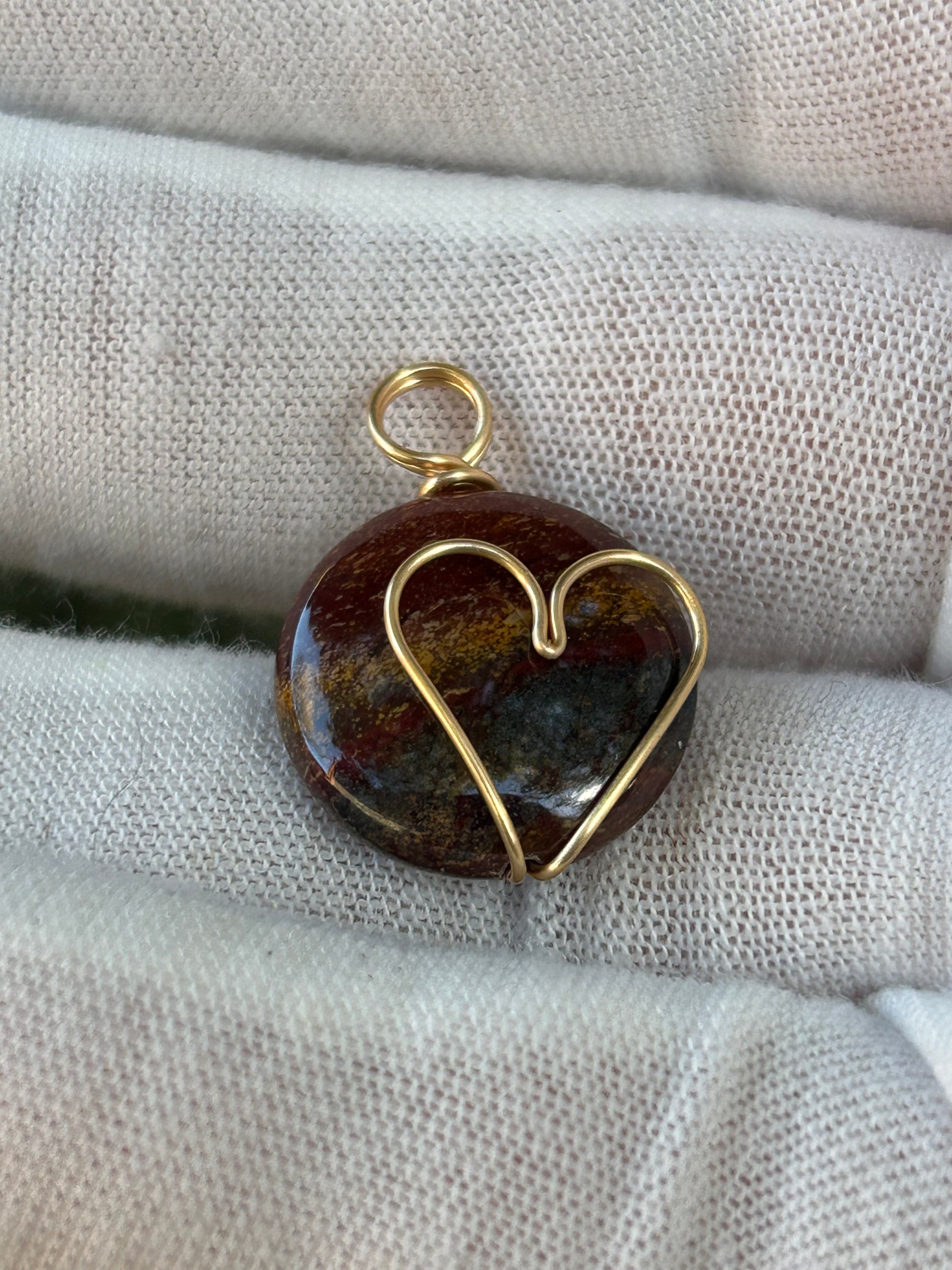 Small round pollished tigers eye pendant with gold wrapped heart