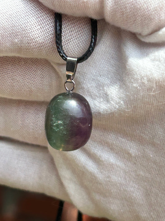 Small fluorite polished pendant with green purple tones and silver pendant attachment with black cord necklace