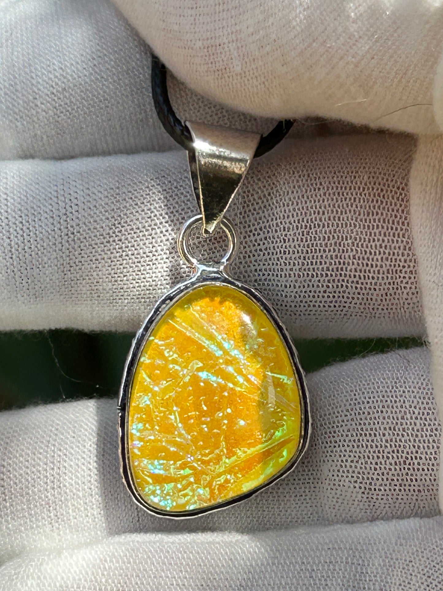 dichroic glass pendant with 925 sterling silver plated setting and black cord necklace