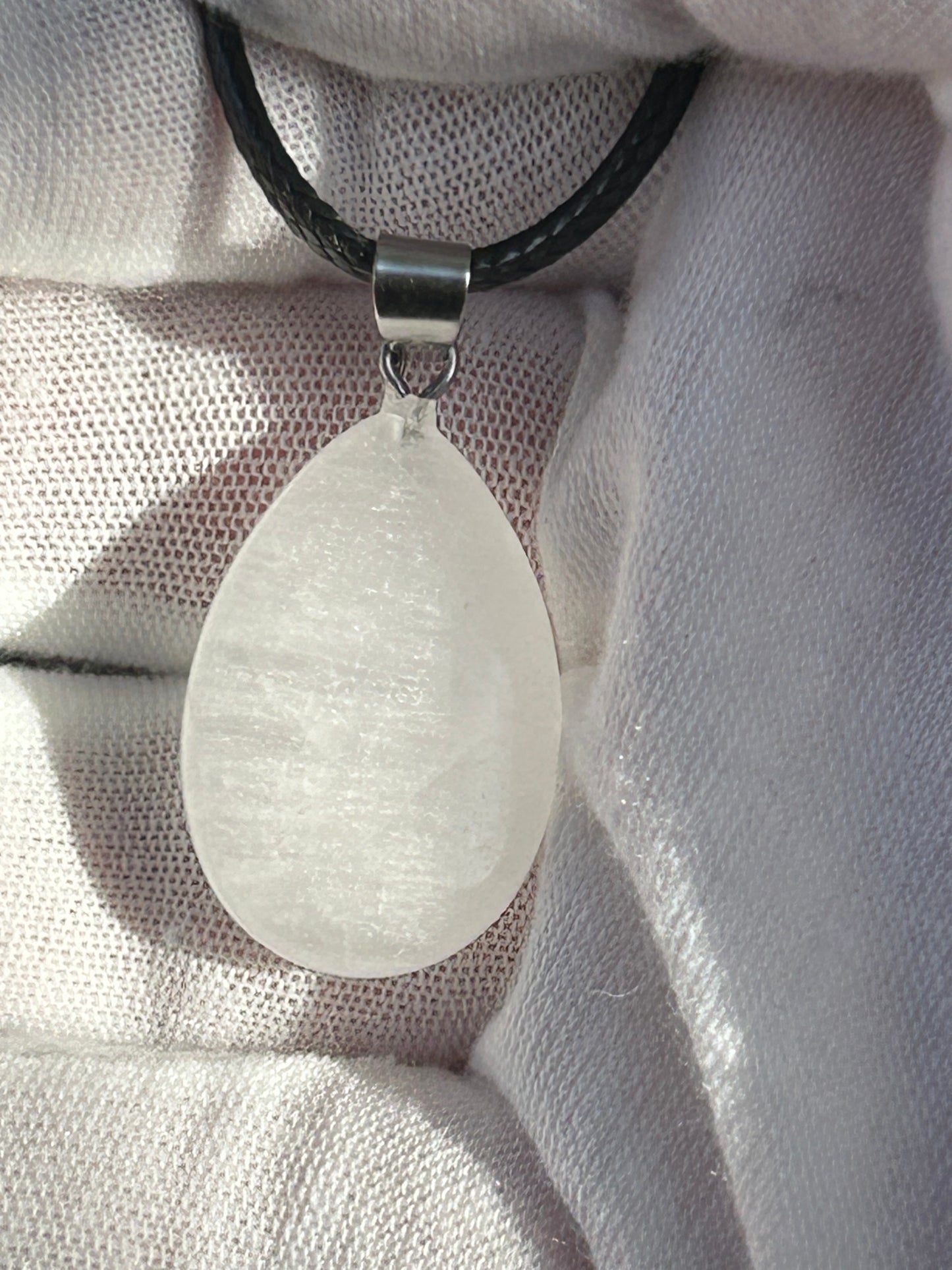 White Quartz Polished Rain Drop Pendant with silver pendant attachment and black cord necklace