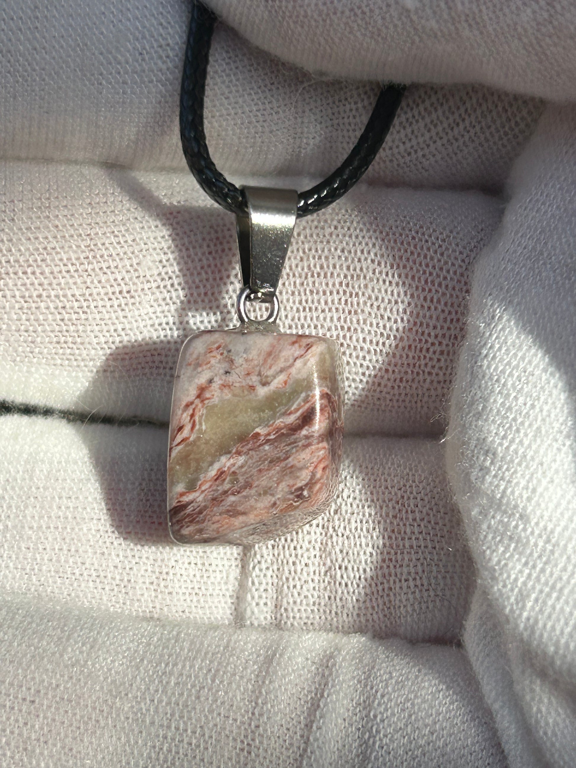 Crazy Lace Agate Polished Stone Pendant with silver pendant attachment and black cord necklace