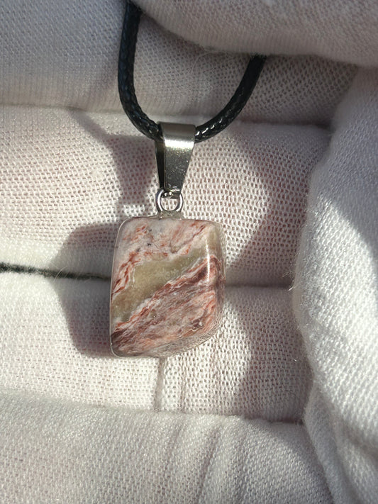 Crazy Lace Agate Polished Stone Pendant with silver pendant attachment and black cord necklace